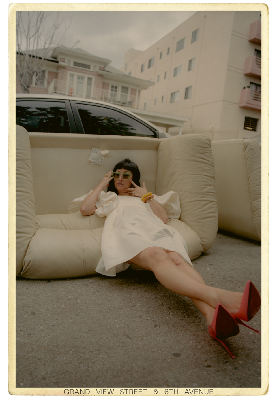 Christine Y. Kim lays on a couch left on the sidewalk