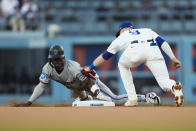 Miami Marlins' Jazz Chisholm Jr., left, steals second base ahead of a tag by Los Angeles Dodgers second baseman Gavin Lux (9) during the first inning of a baseball game in Los Angeles, Monday, May 6, 2024. (AP Photo/Ashley Landis)