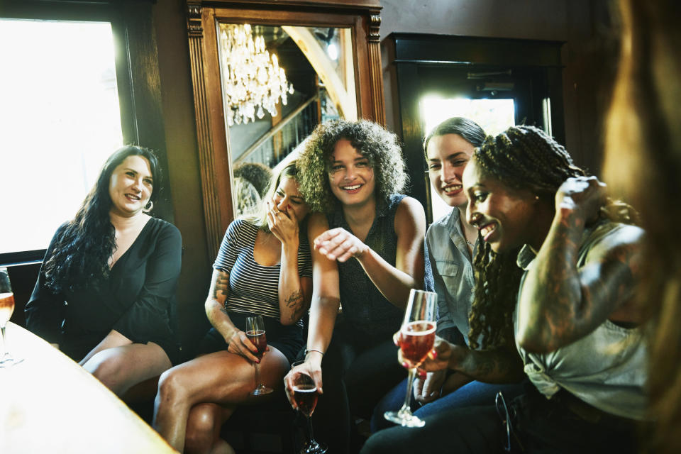 A group of friends at a bar laughing