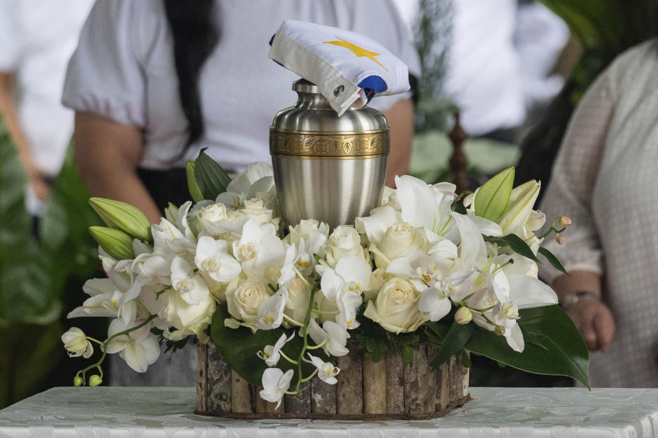 A Philippine flag is placed on top of the urn of former Philippine President Fidel Ramos during his state funeral at the Heroes' Cemetery in Taguig City, Philippines, Tuesday, Aug. 9, 2022. Ramos was laid to rest in a state funeral Tuesday, hailed as an ex-general, who backed then helped oust a dictatorship and became a defender of democracy and can-do reformist in his poverty-wracked Asian country. Ramos died at age 94. (Lisa Marie David/Pool Photo via AP)