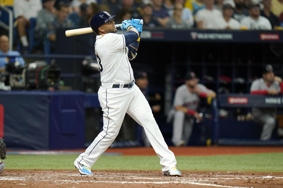 Tampa Bay Rays' Nelson Cruz watches his solo home run against the Boston Red Sox during the third inning of Game 1 of a baseball American League Division Series, Thursday, Oct. 7, 2021, in St. Petersburg, Fla. (AP Photo/Chris O'Meara)