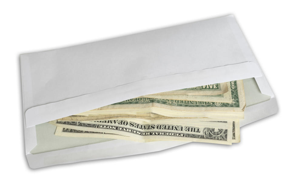 Dollar bills sticking out of a white envelope