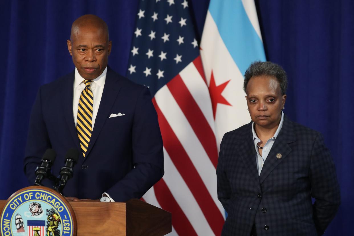 New York City Mayor Eric Adams, left, and Chicago Mayor Lori Lightfoot hold a press conference at City Hall in March 2022. 