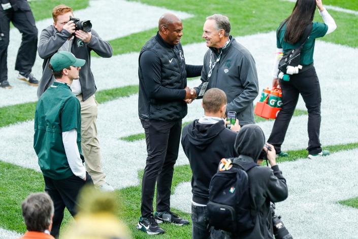 Michigan State head coach Mel Tucker, left, shakes hands with former coach Mark Dantonio before the Michigan game at Spartan Stadium in East Lansing on Saturday, Oct. 30, 2021.
