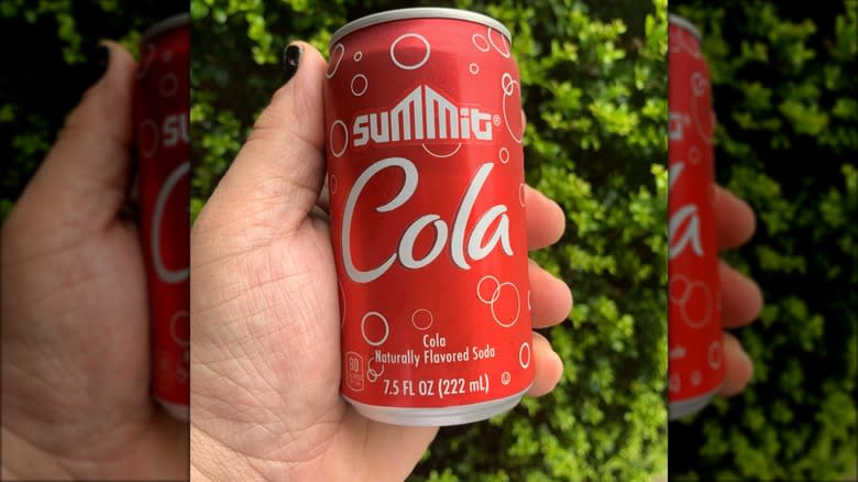 hand holding can of Summit Cola