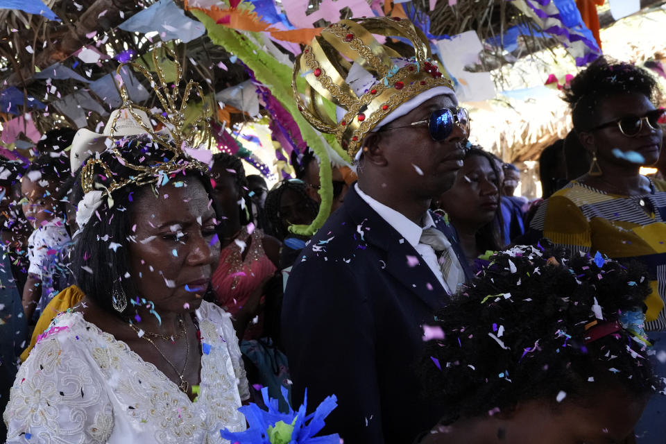 Adonildes da Cunha, right, Emperor, and Nilda dos Santos, left, Queen, arrive for a celebration after a Mass in the chapel of the Kalunga quilombo, during the culmination of the week-long pilgrimage and celebration for the patron saint "Nossa Senhora da Abadia" or Our Lady of Abadia, in the rural area of Cavalcante in Goias state, Brazil, Monday, Aug. 15, 2022. Devotees, who are the descendants of runaway slaves, celebrate Our Lady of Abadia at this time of the year with weddings, baptisms and by crowning distinguished community members, as they maintain cultural practices originating from Africa that mix with Catholic traditions. (AP Photo/Eraldo Peres) (AP Photo/Eraldo Peres)