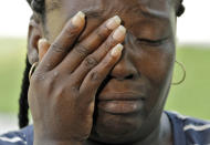 <p>Krystle Martin cries as she speaks to the media near a makeshift memorial for the fatal shootings at Pulse Orlando nightclub, June 13, 2016, in Orlando, Fla. (AP Photo/Chris O’Meara) </p>