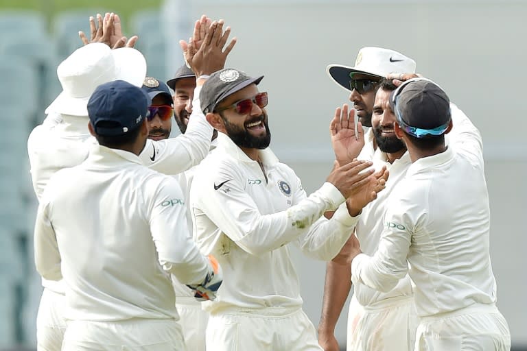 India's captain Virat Kohli (C) celebrates the wicket of Australia's Peter Handscomb with his team during day four of the first Test cricket match at the Adelaide Oval on December 9, 2018