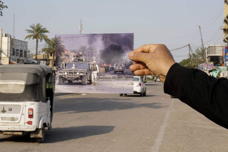 A photograph of U.S. troops securing the area after explosives went off in Baghdad's Palestine Street Wednesday, Dec. 31, 2003, iis inserted into the scene at the same location Friday, March 24, 2023. 20 years after the U.S. led invasion on Iraq and subsequent war. (AP Photo/Hadi Mizban)