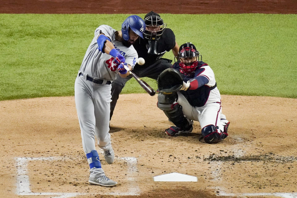 Los Angeles Dodgers Edwin Rios hits a home run against the Atlanta Braves during the third inning in Game 4 of a baseball National League Championship Series Thursday, Oct. 15, 2020, in Arlington, Texas. (AP Photo/Sue Ogrocki)