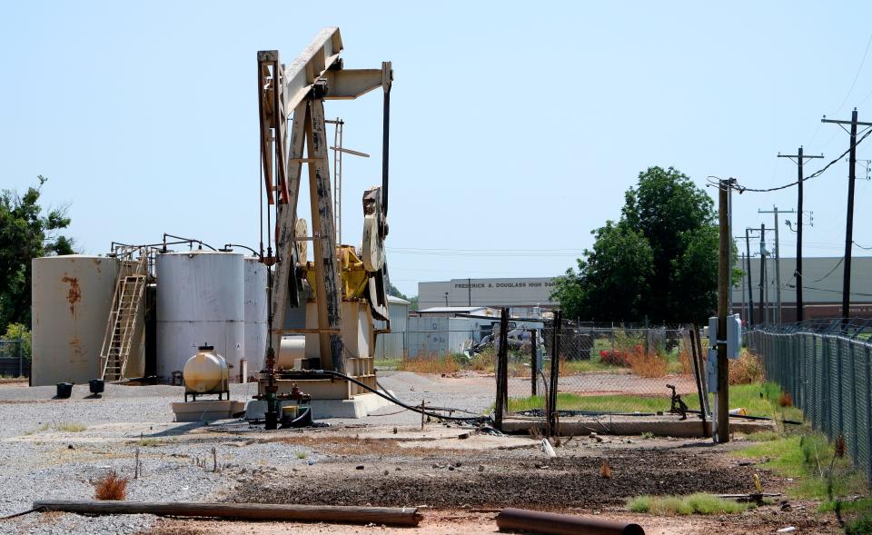 Oil pumps and storage tanks can be seen July 28 directly west of Douglass High School.