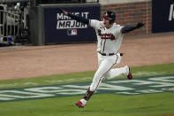 Atlanta Braves' Austin Riley celebrates after hitting the game winning RBI single to score Atlanta Braves' Ozzie Albies in the ninth inning in Game 1 of baseball's National League Championship Series against the Los Angeles Dodgers Saturday, Oct. 16, 2021, in Atlanta. The Braves defeated the Dodgers 3-2 to take game 1.(AP Photo/John Bazemore)