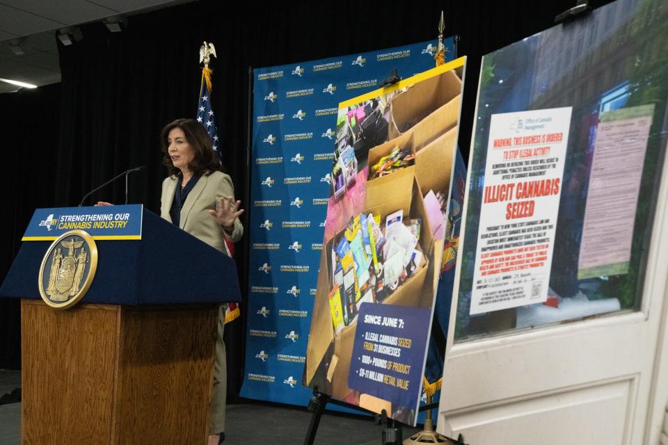 During a media briefing in Brooklyn, Gov. Kathy Hochul displayed photos of some of the 1,000 pounds of illicit marijuana seized by authorities as part of a crackdown on shops illegally selling cannabis without a state-issued license.