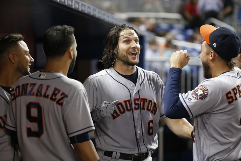 Jake Marisnick (center) hit two homers off the Marlins home-run sculpture. (AP)