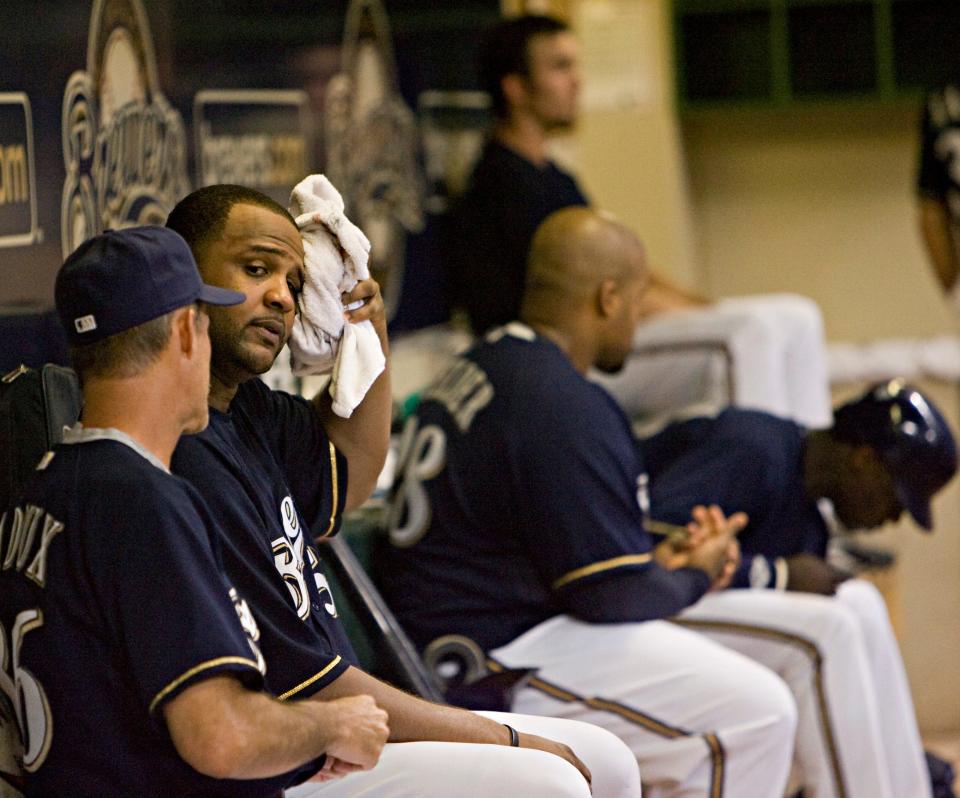 CC Sabathia cools down in the dugout after the sixth inning while talking to pitching coach Mike Maddux against the Rockies on July 8, 2008.