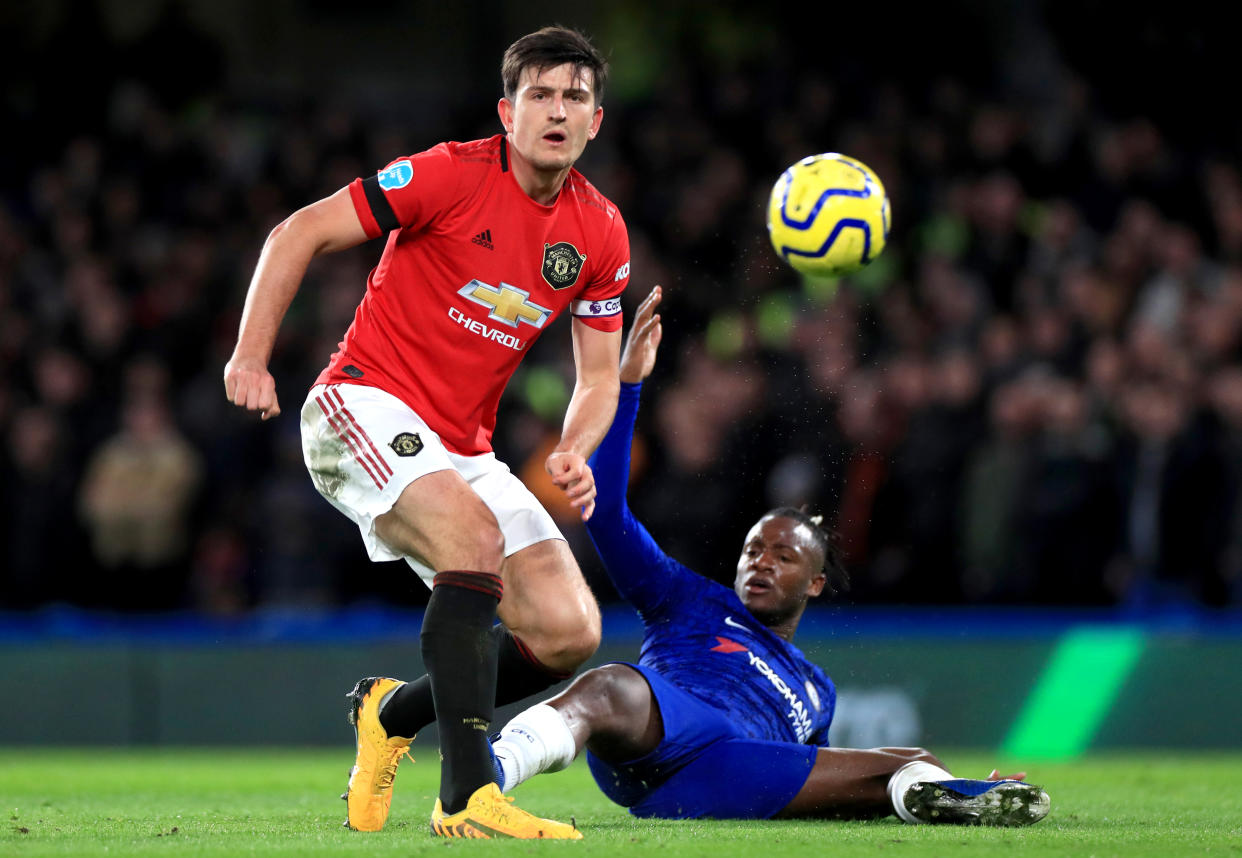 Manchester United's Harry Maguire (left) scored one of the two goals to beat Michy Batshuayi and Chelsea, but not without some help from VAR. (Photo by Mike Egerton/PA Images via Getty Images)