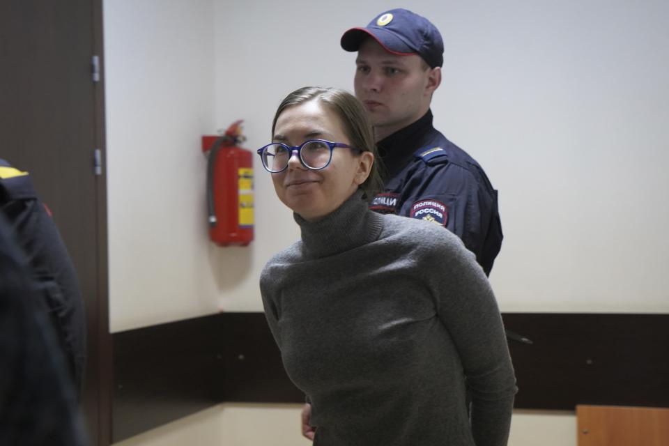 Viktoria Petrova is escorted by police for a hearing in a court in St. Petersburg, Russia, Friday, March 3, 2023. Petrova was sentenced to involuntary treatment in a psychiatric facility after she condemned Russian officials for sending troops into Ukraine on social media. In the last two years, ordinary Russians have been increasingly swept up in an unprecedented government crackdown. (AP Photo)