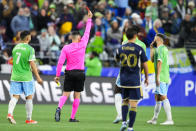 Seattle Sounders midfielder Cristian Roldan (7) turns to watch as defender Jackson Ragen, not seen, is given a red card for a foul against the Vancouver Whitecaps during the first half of an MLS soccer match Saturday, April 20, 2024, in Seattle. (AP Photo/Lindsey Wasson)