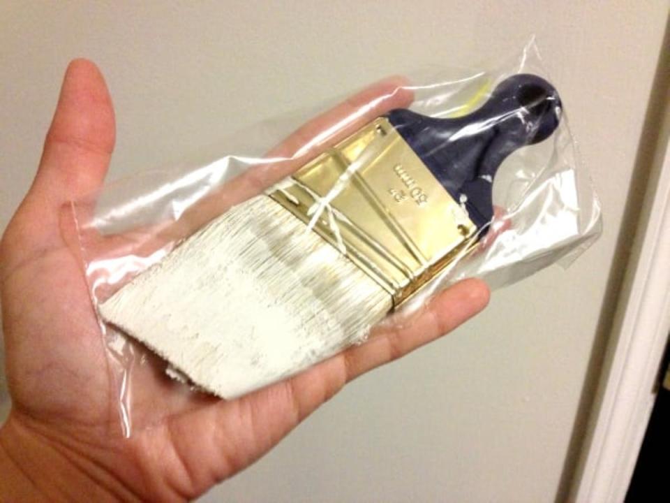 Wet paint brush in a plastic bag.