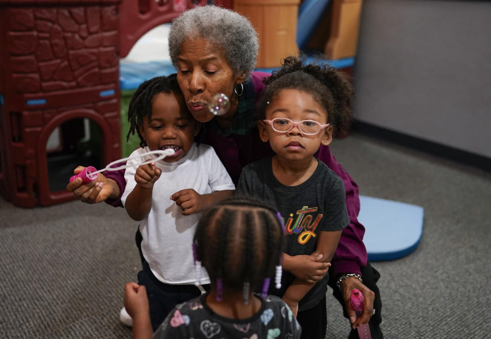 Toddler teacher Janice Bradley blows bubbles with a toddler group at the Life Learning Center - Head Start, in Cincinnati, Tuesday, Nov. 21, 2023. A new plan from the Biden administration could significantly increase salaries for hundreds of low-paid early childhood teachers caring for the country's poorest children but might also force some centers to cut enrollment. (AP Photo/Carolyn Kaster)