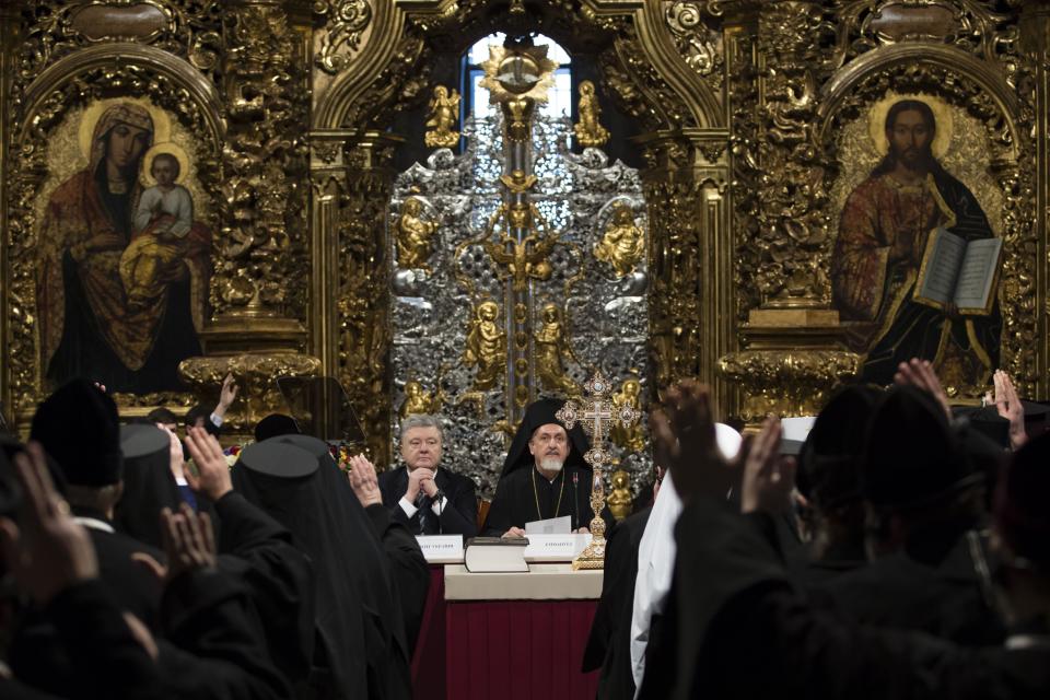 Ukrainian President Petro Poroshenko, center left, attends a closed-door synod of three Ukrainian Orthodox churches to approve the charter for a unified church and to elect leadership in the St. Sophia Cathedral in Kiev, Ukraine, Saturday, Dec. 15, 2018. Poroshenko has told the crowd "the creation of our Church is another declaration of Ukraine's independence and you are the main participants of this historic event." (Mikhail Palinchak, Ukrainian Presidential Press Service/Pool Photo via AP)