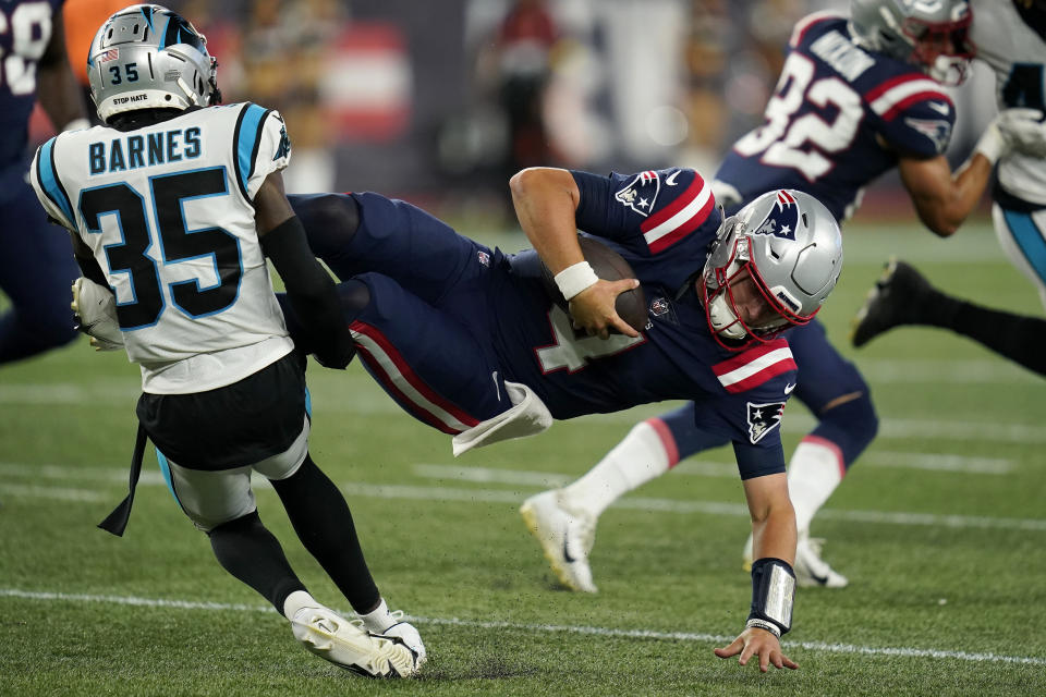 Carolina Panthers cornerback Kalon Barnes (35) brings down New England Patriots quarterback Bailey Zappe during the second half of a preseason NFL football game, Friday, Aug. 19, 2022, in Foxborough, Mass. (AP Photo/Charles Krupa)