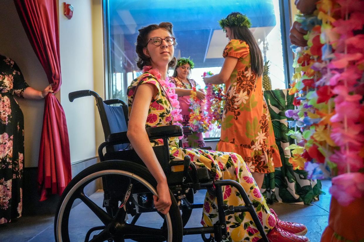 Visnja Ostojic, of Cranston, rolls into the Hasbro Children's Hospital Prom Friday night to music and the draping of Hawaiian leis at the aloha-themed dance.