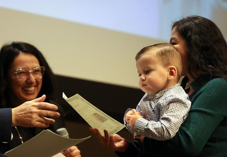 A young child receives his certificate of citizenship during a naturalization ceremony at the Salt Lake City Public Library in Salt Lake City on Wednesday, Feb. 14, 2024. | Kristin Murphy, Deseret News