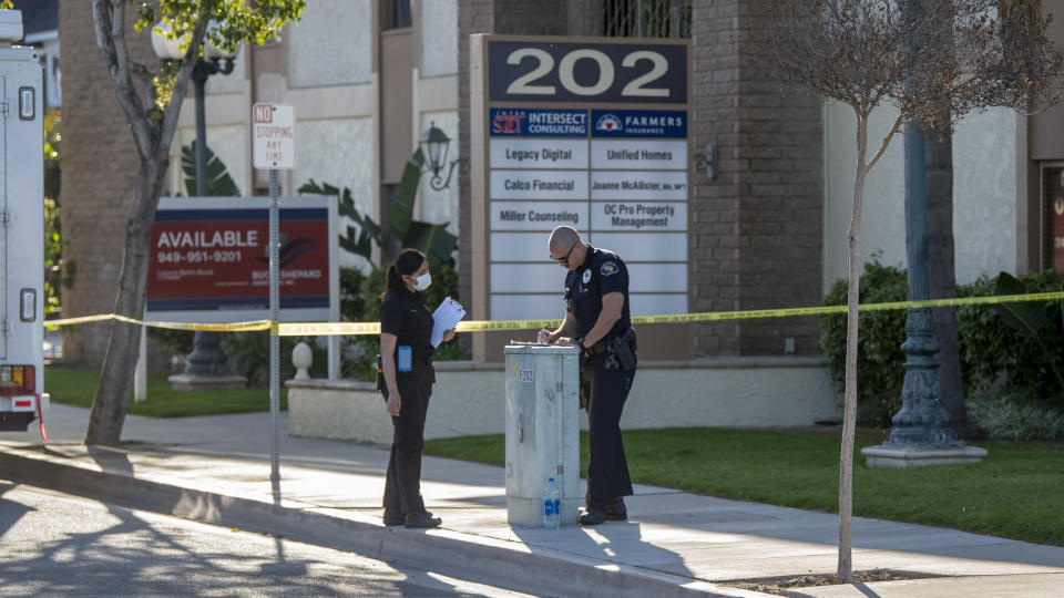 Officials work outside the scene of a shooting, Thursday, April 1, 2021 in Orange, Calif. The gunman who killed four people and wounded a fifth at an office complex knew all the victims either through business or personally, Southern California police said Thursday. (Paul Bersebach/The Orange County Register via AP)