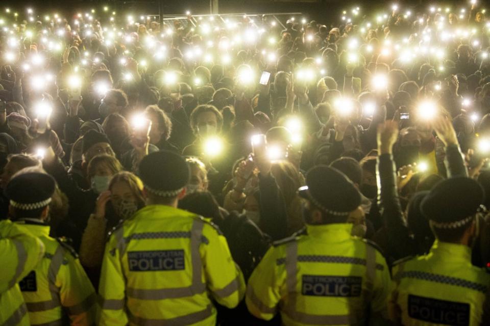 People turn on their phone torches as they gather in Clapham Common, London, for a vigil for Sarah Everard (PA) (PA Wire)