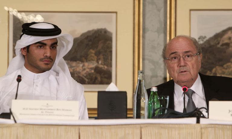 Chairman of the Qatar 2022 bid committee Sheikh Mohammed bin Hamad al-Thani (left) and FIFA president Sepp Blatter attend a press conference in the Qatari capital Doha on November 9, 2013