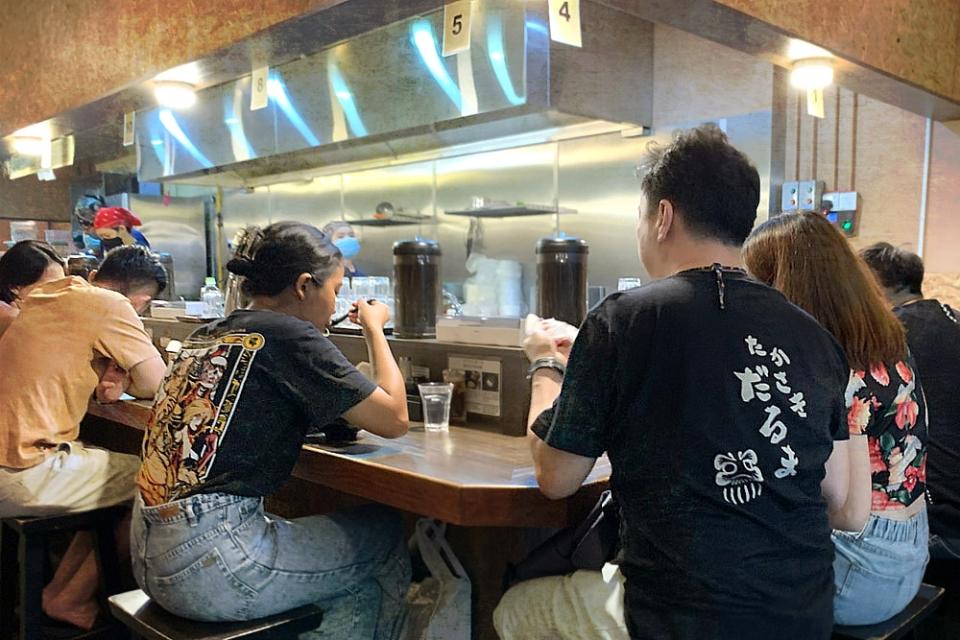 The ramen bar offers counter seating with views of the open kitchen.