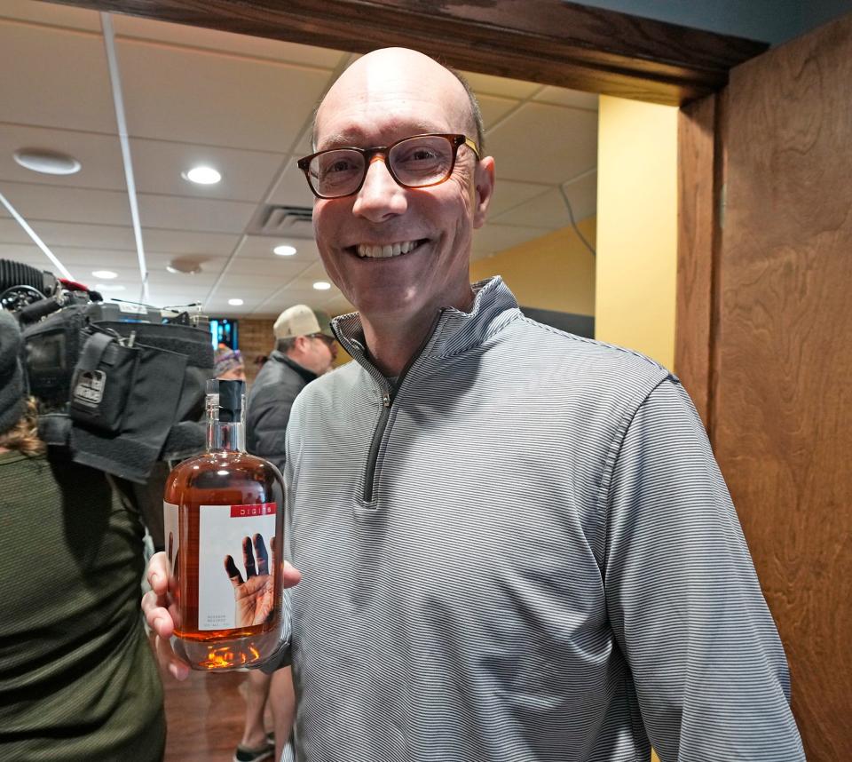 John Lane, of Wauwatosa, holds up his bottle of Scottie Pippen’s Digits Whiskey during Chicago Bulls legend and 6 time NBA champion, Scottie Pippen during his stop at Ray's Wine and Spirits in Wauwatosa on Wednesday, Feb. 8, 2023. Pippen was in town to tout and sign bottles of his Digits Whiskey for fans.