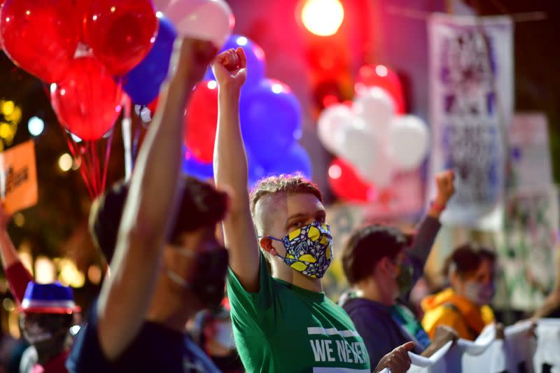 Activists raise their fists in solidarity across the street from where votes are being counted, two days after the 2020 U.S. presidential election, in Philadelphia