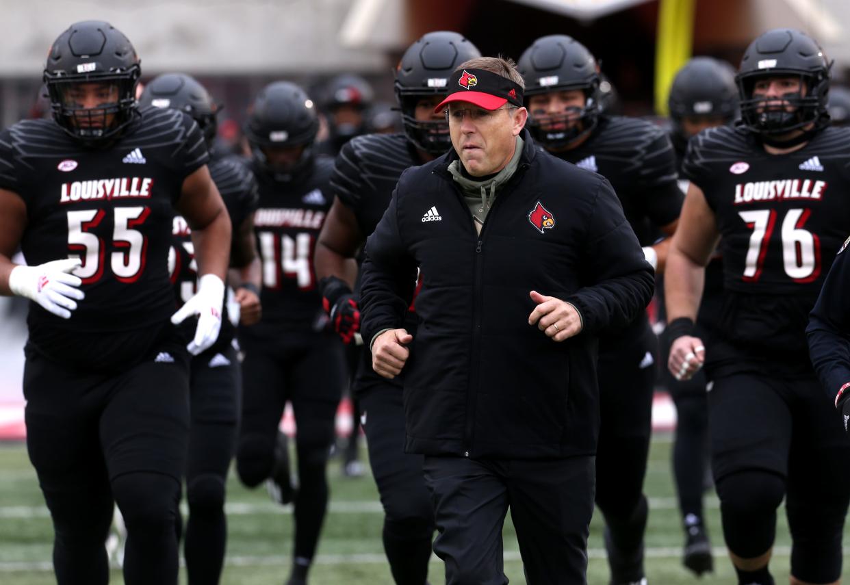 Louisville Scott Satterfield and the rest of the football team comes out before the game. Nov. 13, 2021