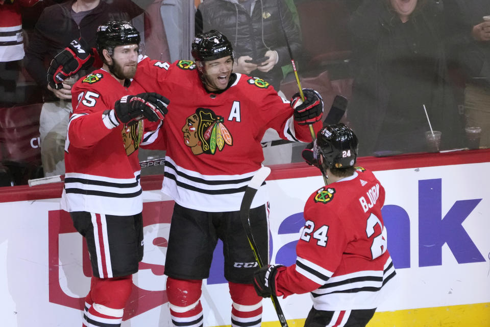 Chicago Blackhawks' Seth Jones, center, celebrates with Anders Bjork (24) and Jarred Tinordi after scoring during the second period of an NHL hockey game against the Ottawa Senators, Monday, March 6, 2023, in Chicago. (AP Photo/Charles Rex Arbogast)