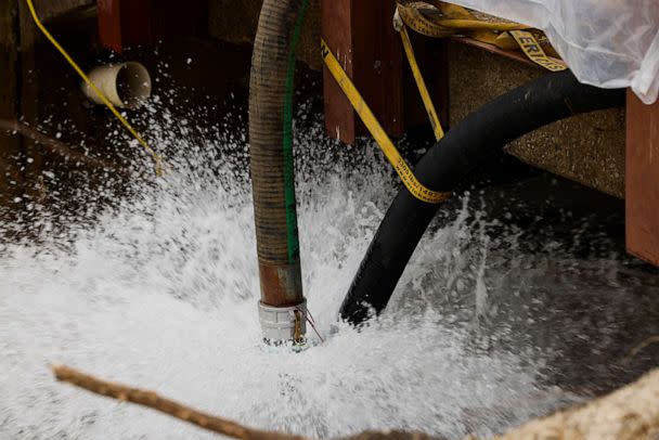 PHOTO: Water is pumped into a creek for aeration, Feb. 14, 2023, in East Palestine, Ohio. A train operated by Norfolk Southern derailed on February 3, releasing toxic fumes and forcing evacuation of residents. (Angelo Merendino/Getty Images)