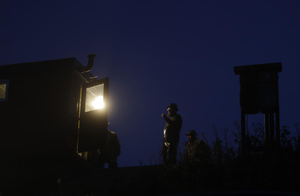 In this picture taken on Thursday, Nov. 15, 2018, fishermen prepare for the traditional fish haul of the Krcin pond near the village of Mazelov, Czech Republic. Czechs will have to pay more for their traditional Christmas delicacy this year after a serious drought devastated the carp population this year. (AP Photo/Petr David Josek)