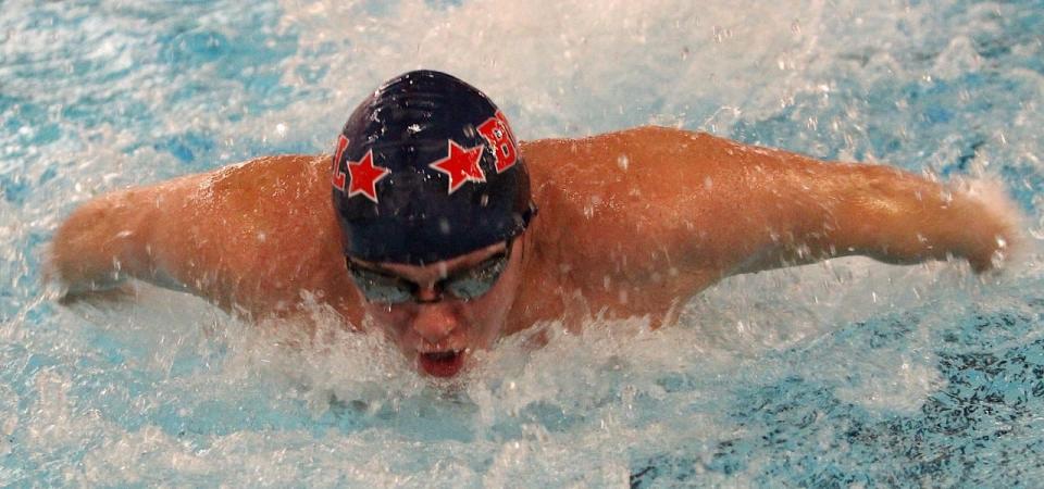 BNL senior Alexander Swenson powers to a victory in the 100 butterfly in the season opener against Edgewood.