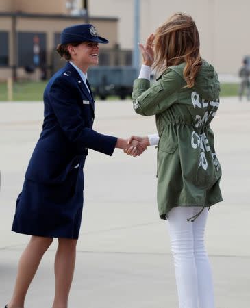 U.S. first lady Melania Trump is greeted on the tarmac by a U.S. Air Force officer as the first lady returns to Washington wearing a Zara design jacket with the phrase "I Really Don't Care. Do U?" after a visit to the U.S.-Mexico border area in Texas, at Joint Base Andrews, Maryland, U.S., June 21, 2018. REUTERS/Kevin Lamarque?