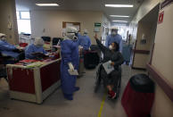 Recovering COVID-19 patient Marisol Ortiz Bernal waves goodbye to the health workers that cared for her at the Mexico City Ajusco Medio General Hospital, Wednesday, Dec. 2. 2020. Mexico continues to report an increase in the number of coronavirus cases, with Mexico City continuing to report the biggest portion of the surge in cases. (AP Photo/Marco Ugarte)