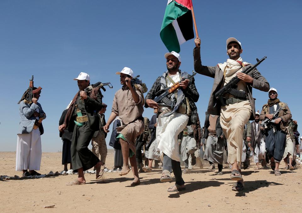 Houthi fighters march during a rally of support for Palestinians in the Gaza Strip and against the U.S. strikes on Yemen, outside Sanaa on Jan. 22, 2024.