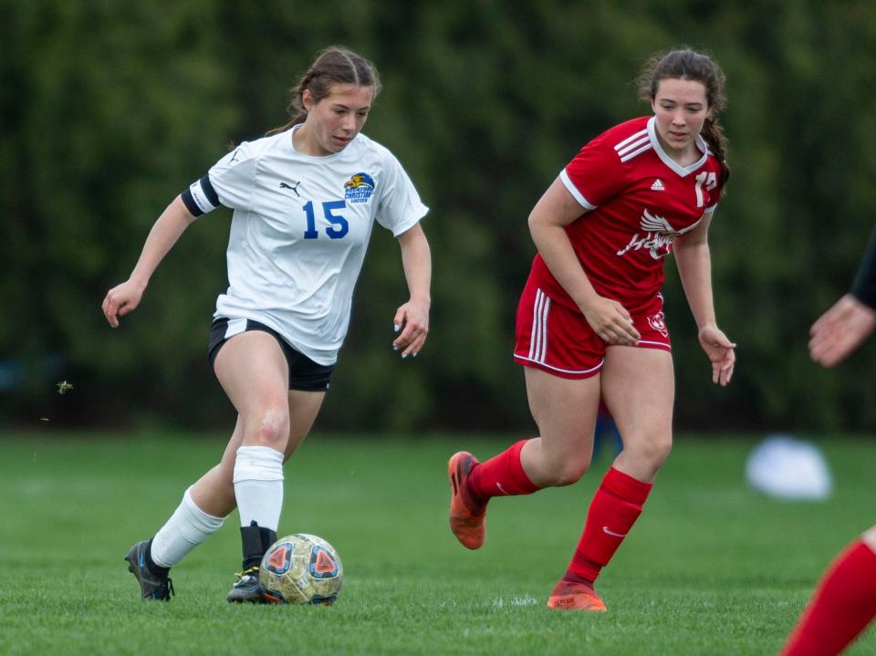 Rockford Christian's Ellen Love takes control of the ball against Oregon's Teagan Champley on Wednesday, April 27, 2022, at Oregon High School in Oregon.