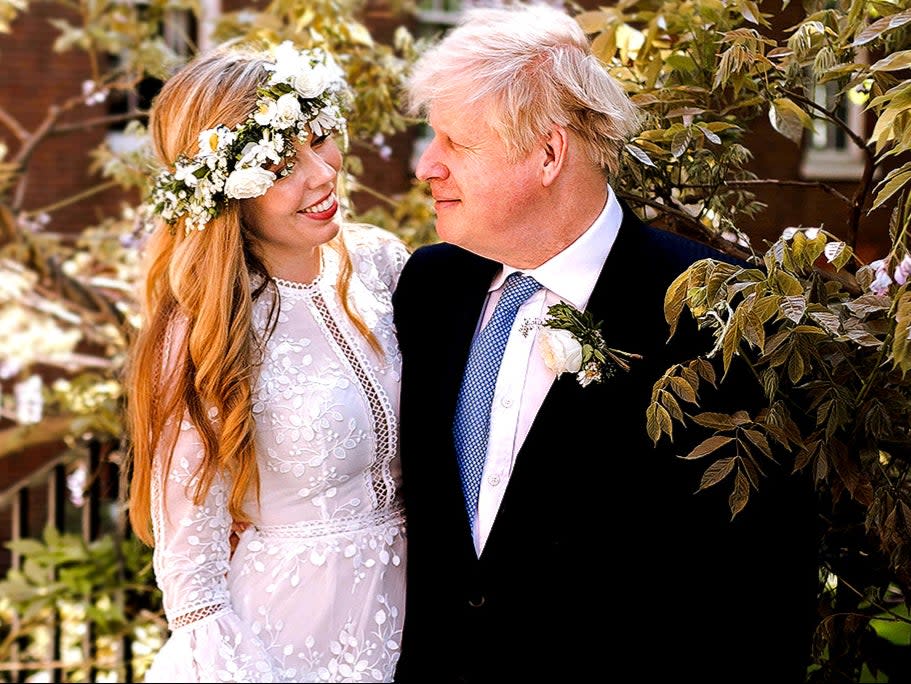 <p>Boris Johnson and Carrie Johnson in the garden of 10 Downing Street after their wedding</p> (PA)