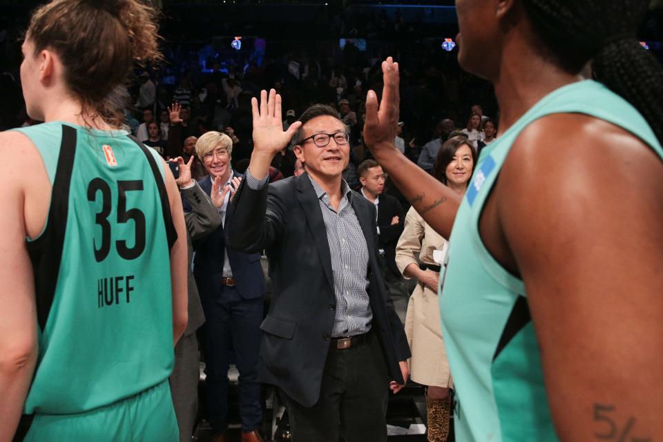 May 9, 2019; New York City, NY, USA; Taiwanese business  Joseph Tsai high fives the New York players after the preseason WNBA game against the China National Team at Barclays Center.  Mandatory Credit: Vincent Carchietta-USA TODAY Sports