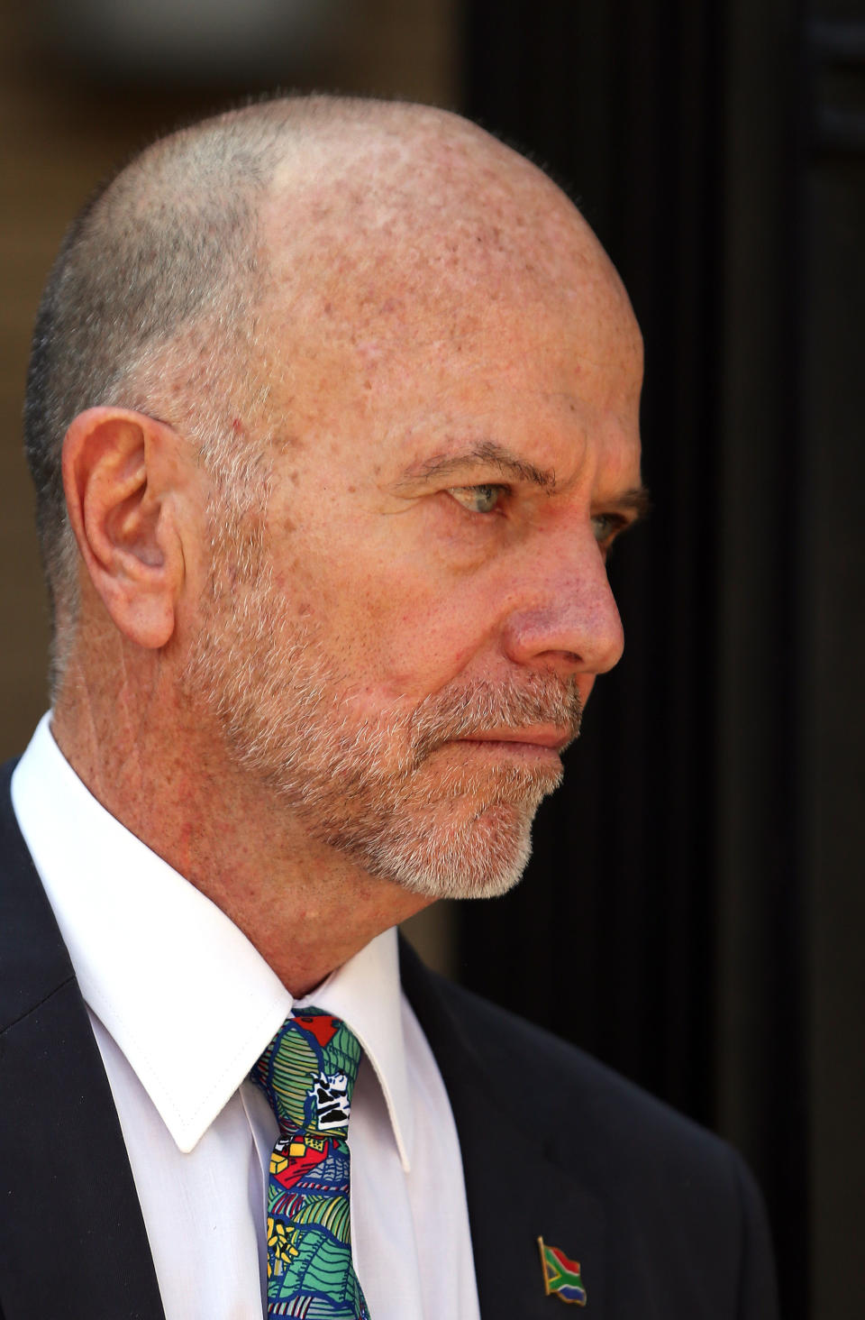 Oscar Pistorius's uncle Arnold Pistorius, leaves the high court in Pretoria, South Africa, Monday, March 24, 2014. Oscar Pistorius is charged with murder for the shooting death of his girlfriend, Reeva Steenkamp, on Valentines Day in 2013. (AP Photo/Themba Hadebe)