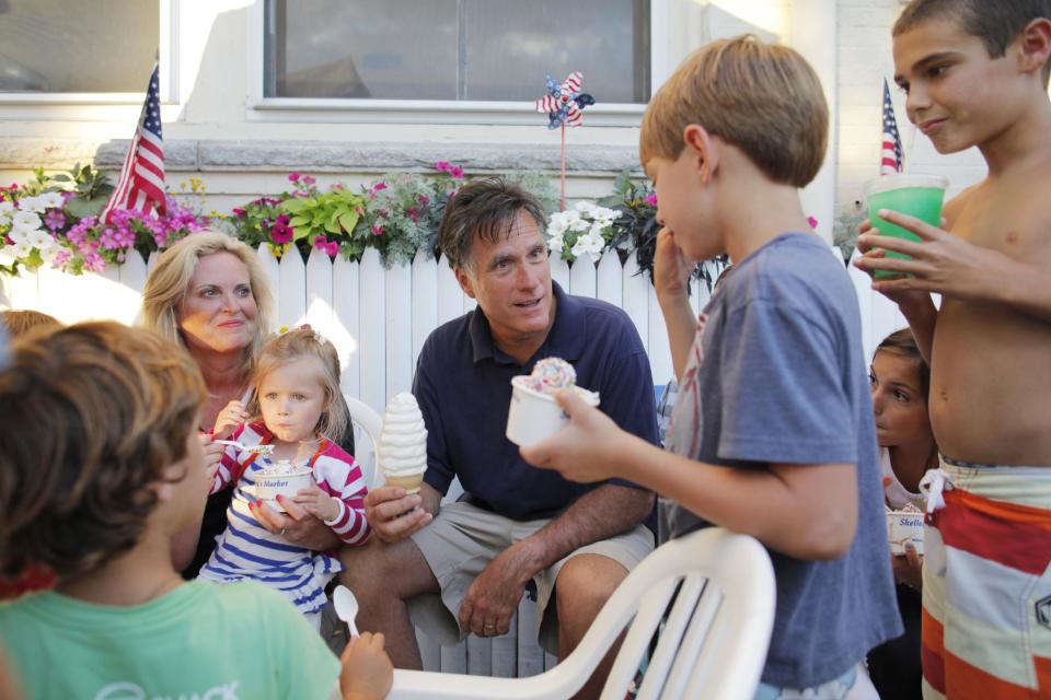 Republican presidential candidate Mitt Romney, center, and his wife Ann, left, have Bailey's Bubble ice cream in Wolfeboro, N.H., Monday, July 2, 2012, as they continue their vacation from the campaign trail. (AP Photo/Charles Dharapak)