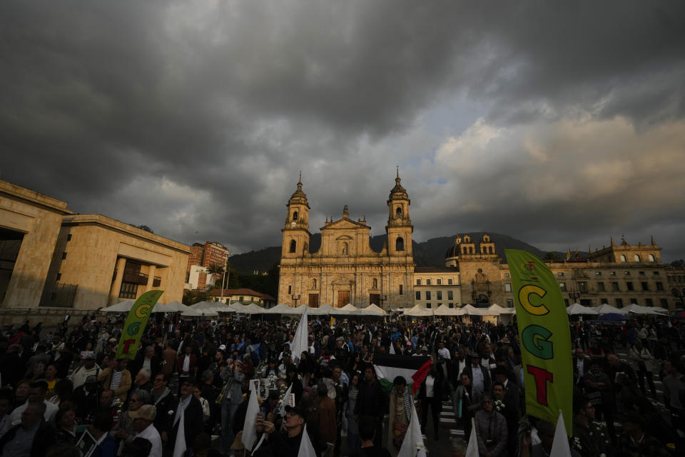 People attend an event to remember former guerrillas and social leaders who have been killed since the 2016 signing of a peace agreement between rebels of the Revolutionary Armed Forces of Colombia, FARC, and the government, in Bogota, Colombia, Tuesday, Feb. 20, 2024. (AP Photo/Fernando Vergara)