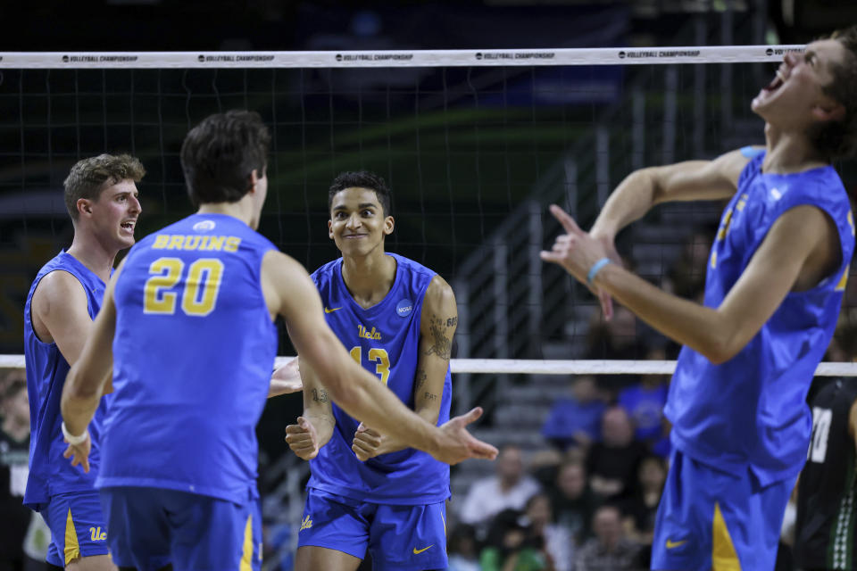 UCLA outside hitter Ethan Champlin (20), middle blocker Merrick McHenry (13), setter Andrew Rowan (7) and outside hitter Alex Knight (12) react during a match against Hawaii in the NCAA college men's volleyball tournament, Saturday, May 6, 2023, in Fairfax, Va. (Julia Nikhinson/Honolulu Star-Advertiser via AP)