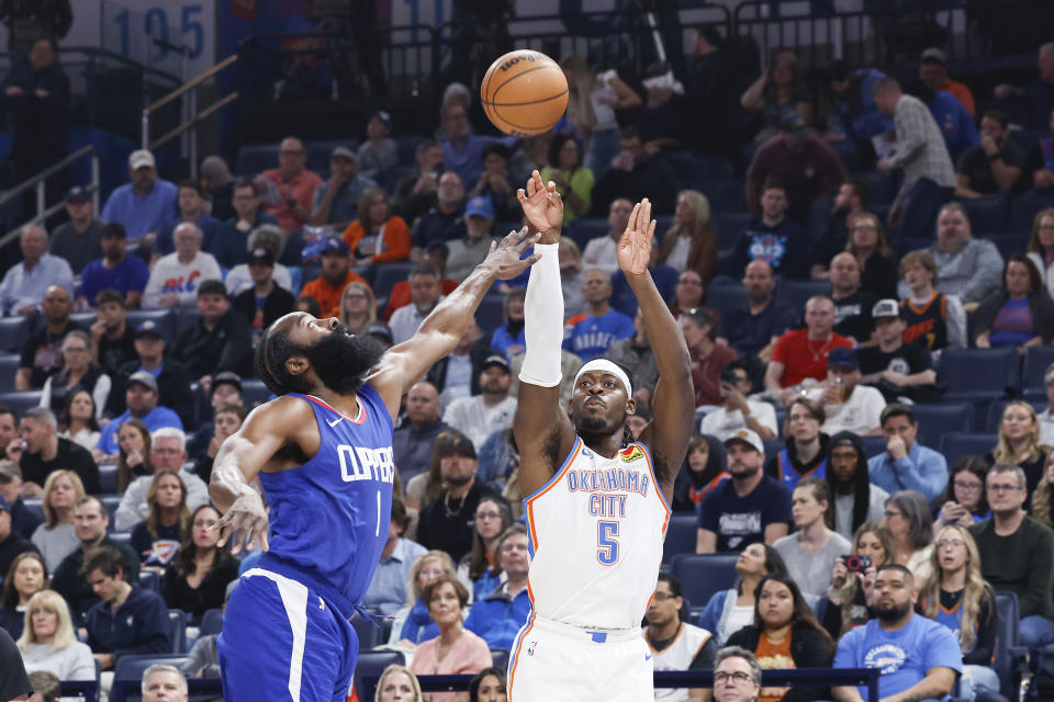 Feb 22, 2024; Oklahoma City, Oklahoma, USA; Oklahoma City Thunder guard <a class="link " href="https://sports.yahoo.com/nba/players/6254/" data-i13n="sec:content-canvas;subsec:anchor_text;elm:context_link" data-ylk="slk:Luguentz Dort;sec:content-canvas;subsec:anchor_text;elm:context_link;itc:0">Luguentz Dort</a> (5) shoots a three point basket as LA Clippers guard James Harden (1) defends during the first quarter at Paycom Center. Mandatory Credit: Alonzo Adams-USA TODAY Sports